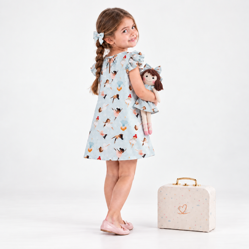 Girl in Ballerina dress holding matching Alice doll, with Petit Case