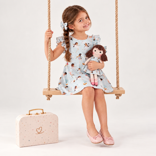 Girl in Ballerina dress holding matching Alice doll, with Petit Case
