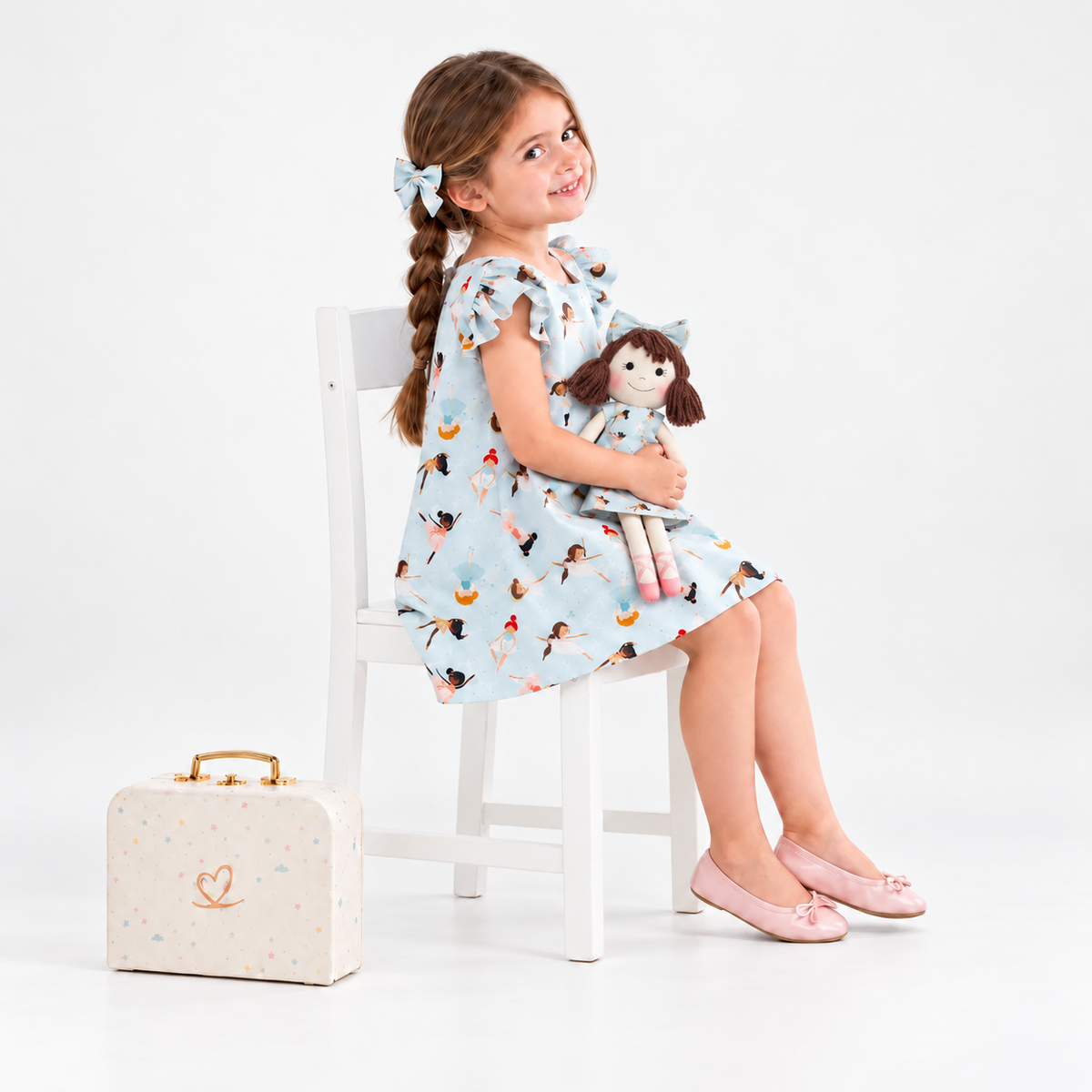 Girl in Ballerina dress holding matching Alice doll, with Petit Case