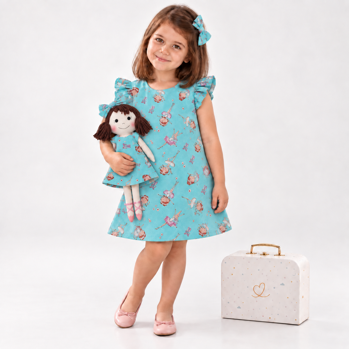 Girl in Ballet dress holding matching Alice doll, with Petit Case