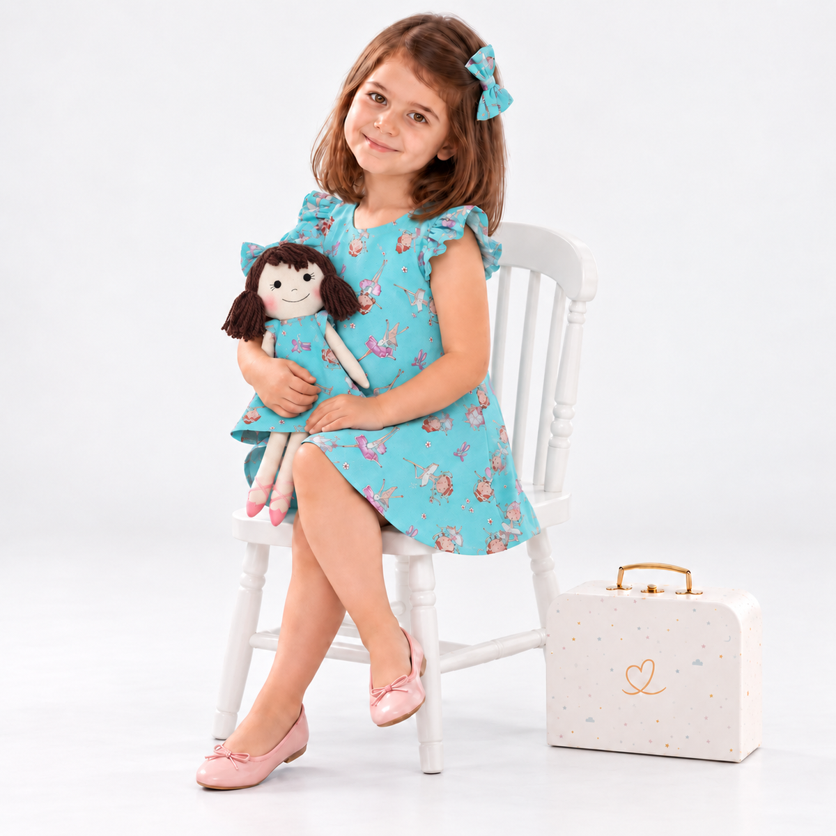 Girl in Ballet dress holding matching Alice doll, with Petit Case