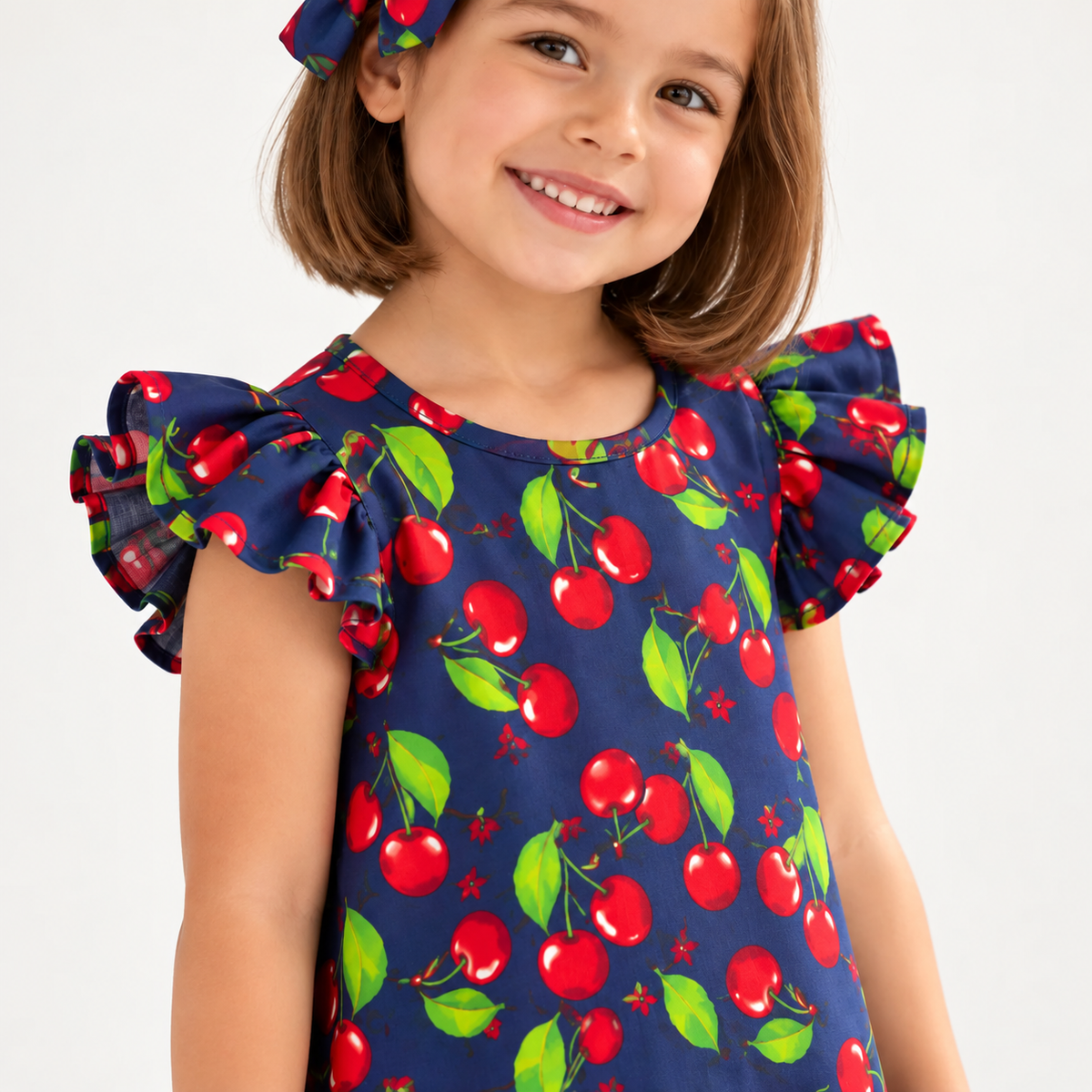 Girl in Cherry dress holding matching Alice doll, with Petit Case