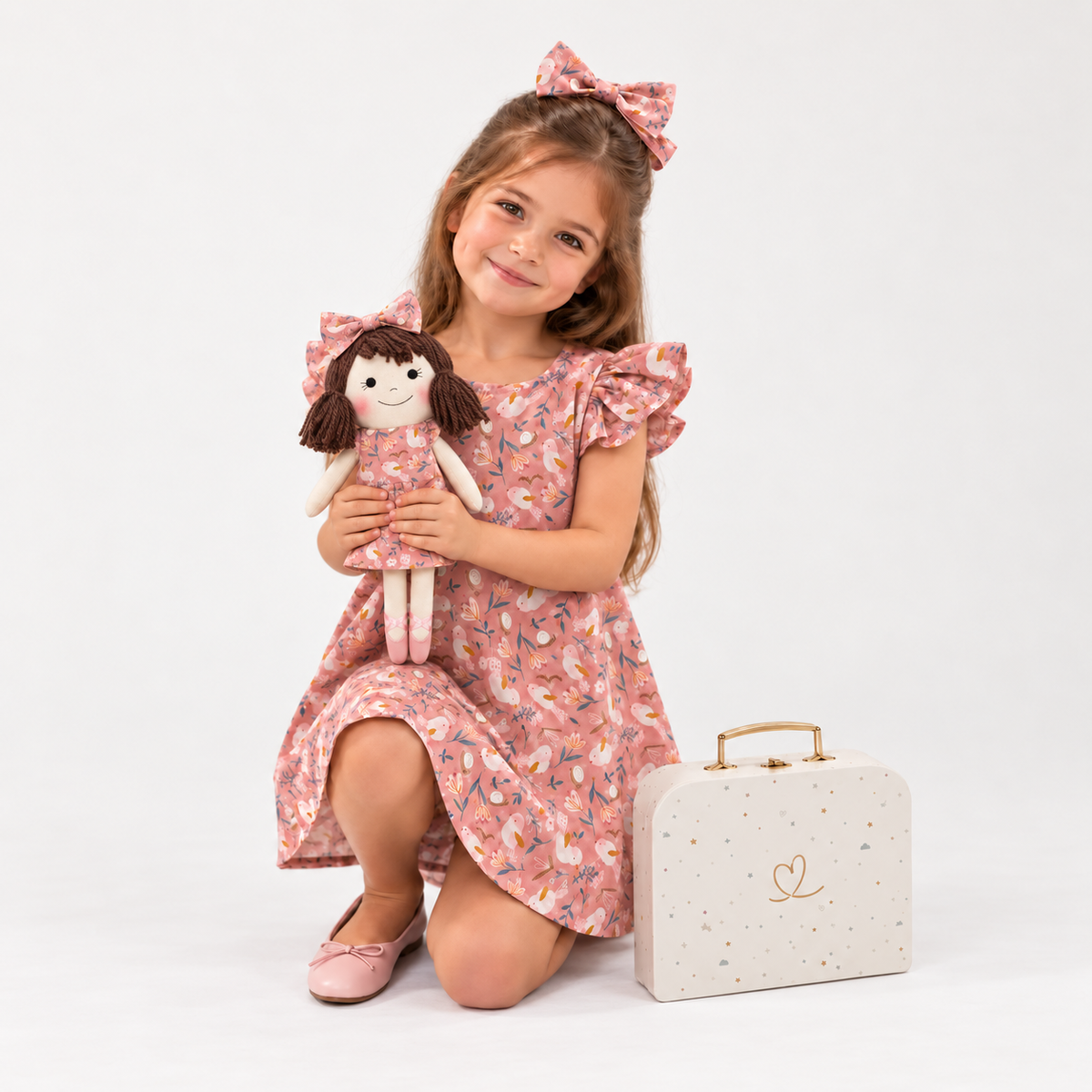 Girl in Garden dress holding matching Alice doll, with Petit Case