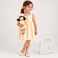Girl in Classic Yellow dress holding matching Alice doll, with Petit Case