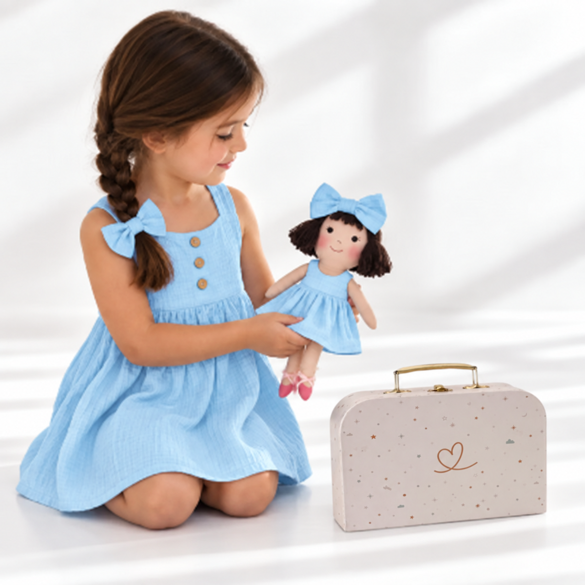 Girl in Classic Blue dress holding matching Alice doll, with Petit Case