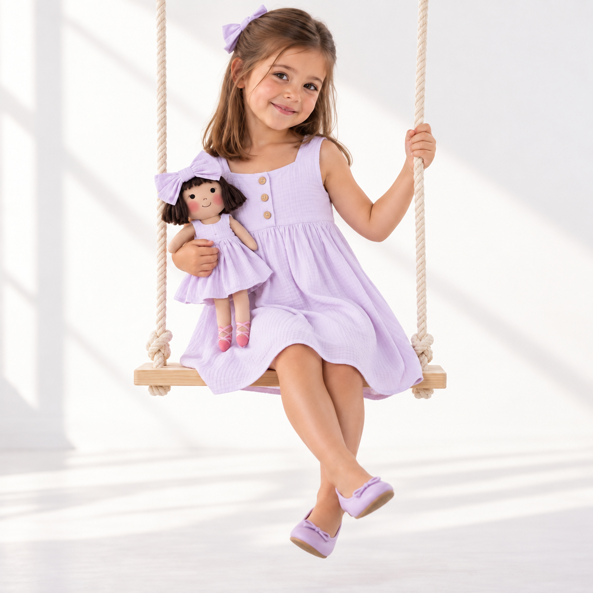 Girl in Classic Lavender dress holding matching Alice doll, with Petit Case