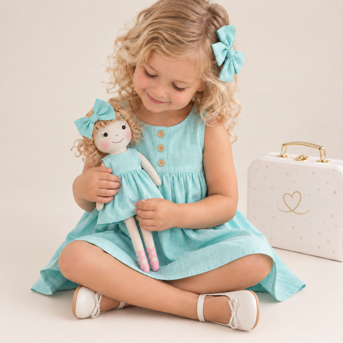 Girl in Classic Green dress holding matching Annie doll, with Petit Case