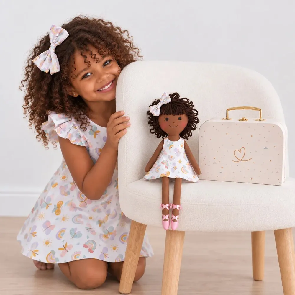 A girl with her matching handmade doll and Petit Case